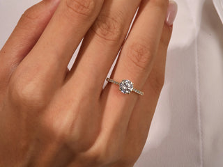 Ethical and sustainable 1.0CT round moissanite ring with sparkling pave band.