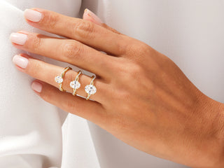 14K rose gold oval moissanite engagement ring with twisted diamond accents