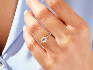 2.0CT round moissanite engagement ring with channel-set side stones and timeless design.