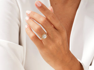 Cushion-cut moissanite halo ring with pavé diamonds, elegant engagement style