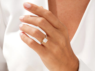 Elegant princess moissanite ring featuring sparkling pave diamonds along the band