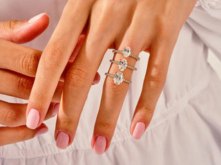 Elevated oval moissanite solitaire set in a graceful cathedral-style pavé band