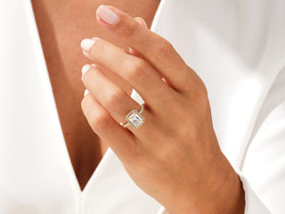 Modern engagement ring featuring a radiant-cut Moissanite center stone surrounded by a halo of pave diamonds