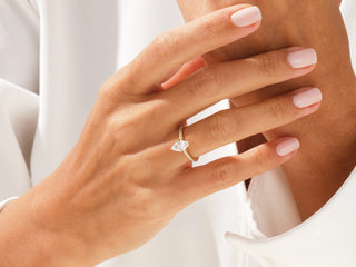 2.0 CT marquise-cut moissanite engagement ring with pavé-set diamonds on a sleek band.