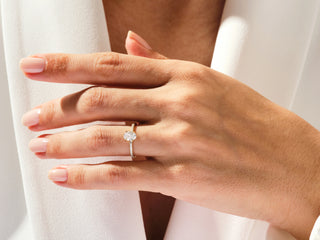 Oval-cut moissanite ring with subtle hidden halo and sparkling pavé diamonds