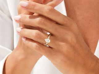 Pear-shaped moissanite diamond ring featuring a twisted pavé setting