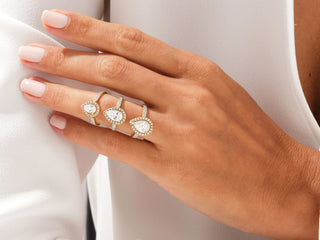 Elegant pear-shaped moissanite ring surrounded by sparkling halo diamonds with double pavé band