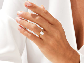 Radiant-cut moissanite ring featuring elegant twisted pavé design