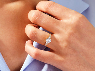 Round-cut Moissanite engagement ring with pave diamonds in white gold