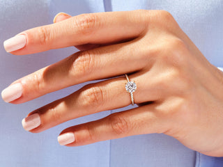 Round-cut moissanite engagement ring with sparkling channel diamonds, timeless style