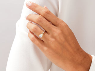 Twisted pave engagement ring featuring 1.00CT cushion cut moissanite and sparkling diamonds