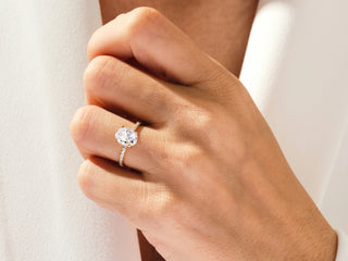 Close-up of a 2.00CT oval-shaped moissanite ring featuring a concealed halo and minimalist setting